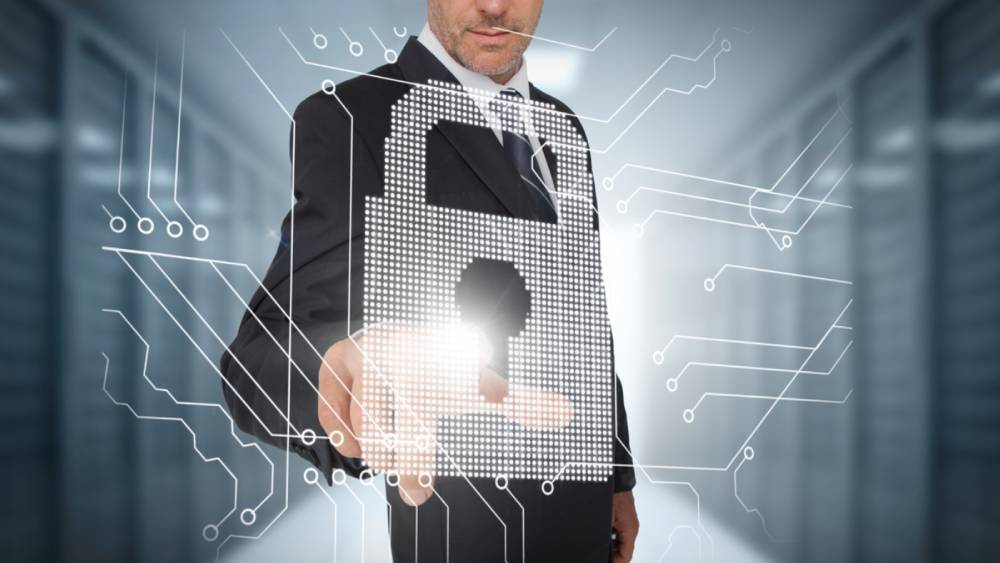 Businessman selecting a futuristic padlock with a data center on the background
